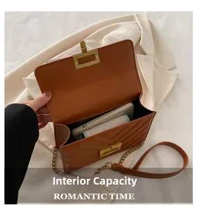 Internal capacity of the caramel quilted chain bag showing phone and wallet storage