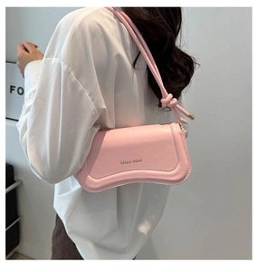 Pink leather shoulder bag with gold Miss Mini logo and decorative knotted strap detail