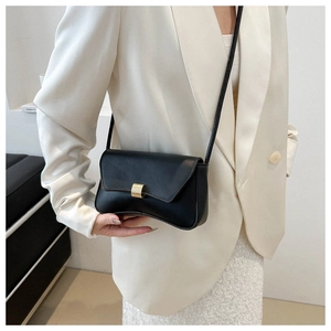 Classic matte black minimalist crossbody bag with gold hardware and crescent curved base