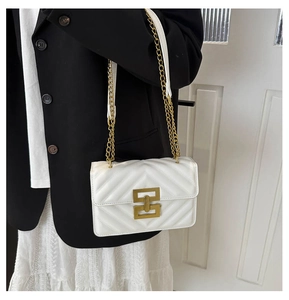 White quilted crossbody bag with V-shaped stitching and golden metal chain strap