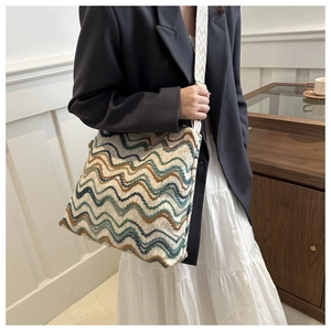 Ethnic knit bucket bag with colorful zigzag patterns and wide jacquard shoulder strap