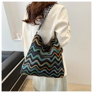Dettaglio della trama a maglia a zigzag colorata e della tracolla geometrica della borsa