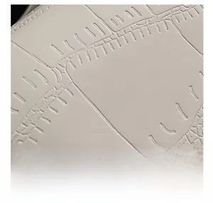 Macro shot of high-quality cream white textured synthetic leather fabric on small square bag
