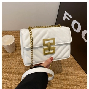 White chevron quilted crossbody bag with gold chain strap and elegant twist lock closure