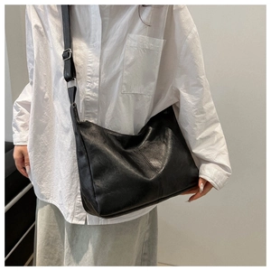 Minimalist black PU leather tote bag with adjustable wide strap for casual daily use