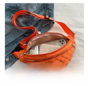 Detail view of orange quilted nylon saddle bag interior showing storage for phone and wallet