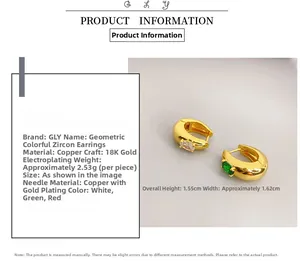 Detail of 18K gold plated copper earrings with inlaid red and green oval cubic zirconia
