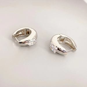 U-shaped thick silver-tone hoop earrings with a prong-set oval cubic zirconia stone