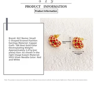 Detail view of red and gold enamel C-shaped stud earrings with 18K gold plating