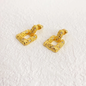 Lava texture gold rectangle drop earrings with zircon inlays in a stylish 45-degree view