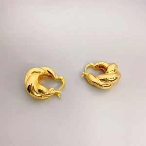 Polished golden twisted rope hoop earrings with a metallic mirror finish for women
