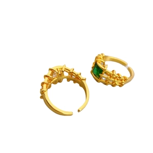 Gold adjustable ring set with green square gemstone and lattice textured design