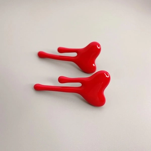 Glossy red fluid heart stud earrings with minimalist polished enamel drop design