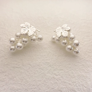 Elegant silver grape cluster earrings with lustrous white pearls on ivory background