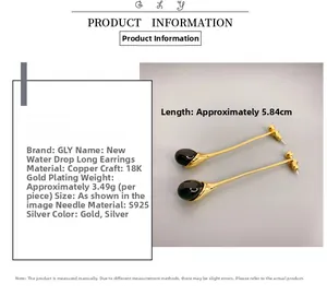 Detailed view of long teardrop earrings with black stones and 18K gold plated copper