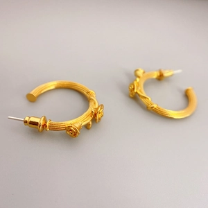 Vintage golden C-shaped hoop earrings with 3D rose relief and textured vine pattern