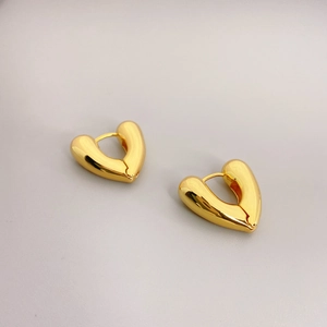 Polished 18K gold heart-shaped hoop earrings for women shown from a 45-degree angle