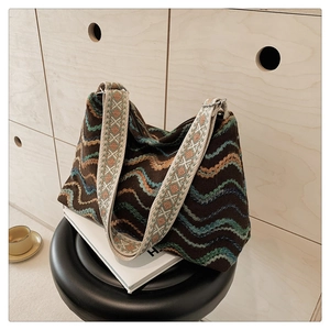 Détail du sac bohème en laine avec broderie ondulée et large bandoulière en jacquard