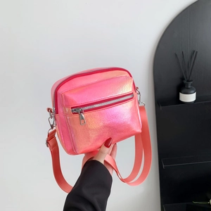 Chic pink iridescent crossbody bag with rainbow metallic sheen and wide shoulder strap