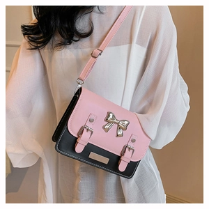 Pink and black color-block crossbody satchel with silver bow and adjustable strap