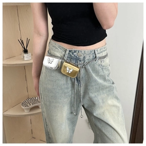 Detail of double silver waist chain with mini gold and silver pouches and butterfly charms