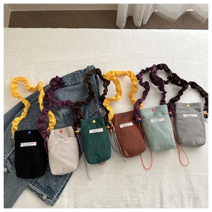 Corduroy crossbody bag details showing six trendy colors and elastic scrunchie strap
