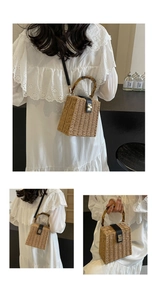 Detail of woven straw box bag with bamboo handle and black leather strap for women