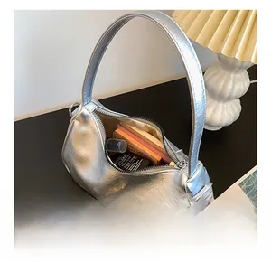 Interior detail of silver crescent bag showing spacious storage for cosmetics and essentials