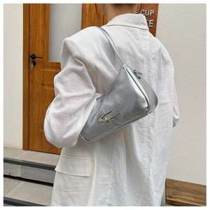 Close-up of silver wrinkled texture crescent bag with metallic finish and buckle