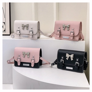 Stylish square crossbody bags with silver bow accents in white, pink, and black colors