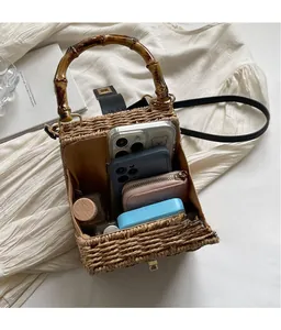 Interior view of woven straw tote bag showing spacious capacity for phone and cosmetics