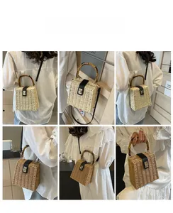 Detail view of woven straw handbag featuring bamboo handles and a gold metal lock closure