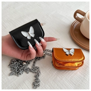 Mini chain bag in black and orange featuring a silver butterfly buckle and long strap