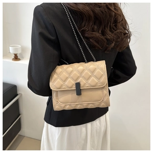 Classic beige quilted chain bag shown on a model's shoulder for a stylish look