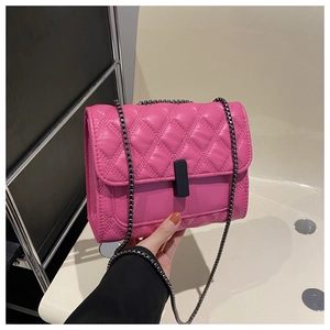 Detail of pink quilted leather small square bag with black metal chain and twist lock