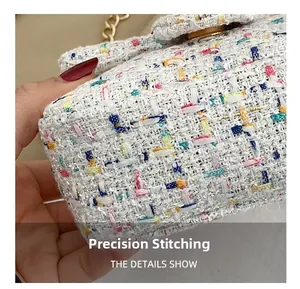Close-up of precise stitching and colorful tweed fabric on a mini crossbody bag