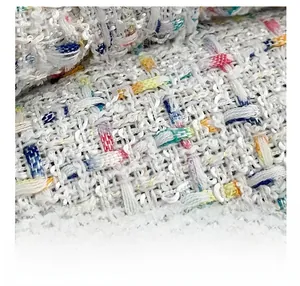 Detailed macro shot of premium tweed fabric with colorful woven threads on a mini bag