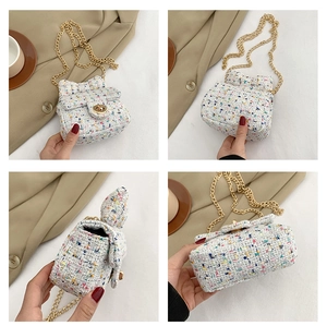 Detail shots of colorful tweed mini bag with bow design and gold metal chain strap