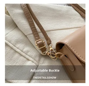 Detail showing adjustable golden buckle and hardware on light brown leather strap