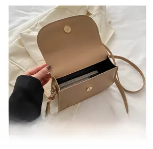 Internal view of beige square crossbody bag showing smartphone storage capacity