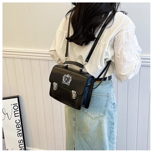 Classic black JK school backpack with white crest and silver metallic buckles details