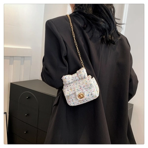 Mini girls' tweed crossbody bag with bow decoration and gold chain strap on model