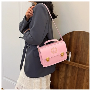 Pink college-style satchel with embroidered logo and vintage gold buckles on model