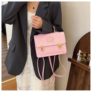 Detailed view of pink PU leather British style backpack with gold embroidery and buckles