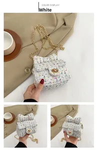 Detail of white tweed girl handbag with floral bow design and golden chain strap