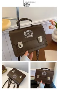 Detail of coffee brown JK messenger bag with shield embroidery and silver buckles