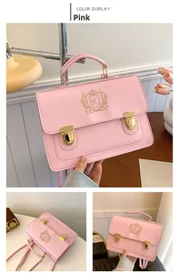 Pink PU leather messenger bag featuring golden shield embroidery and double metal buckles
