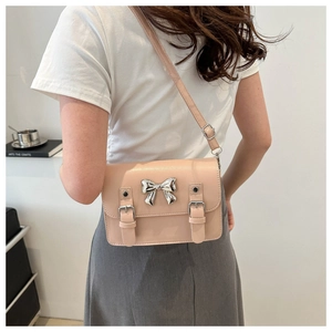 Pink Cambridge style crossbody bag with silver bow accent and adjustable straps for women