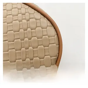 Close-up of woven texture and premium leather trim on khaki shoulder bag detail