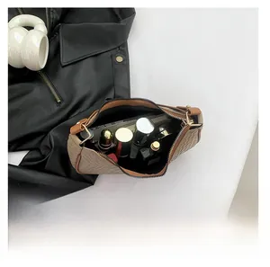 Detailed top view showing internal capacity of the brown woven baguette bag